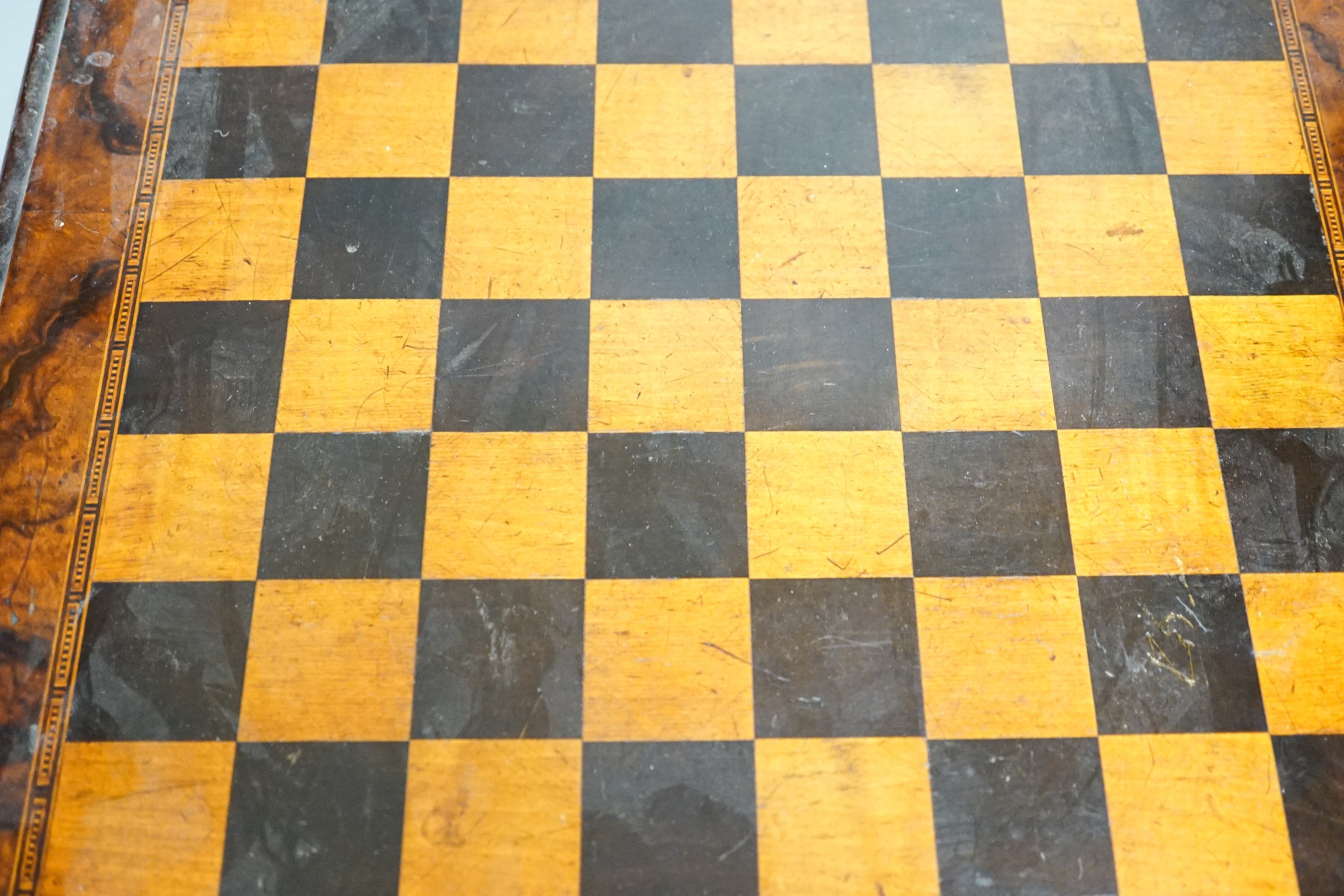 A late 19th century walnut, ebony and sycamore chessboard together with a box set of dominoes, chessboard 41cm x41cm